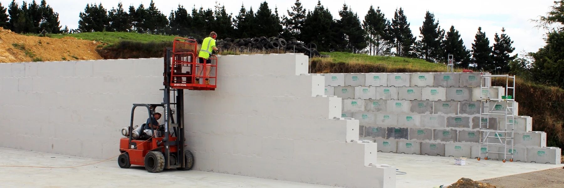 Man installing vertical reinforcing in an Interbloc silage bunker