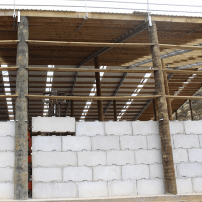 Interbloc 1800 standard concrete block being placed on the final layer of a bulk fertiliser bin