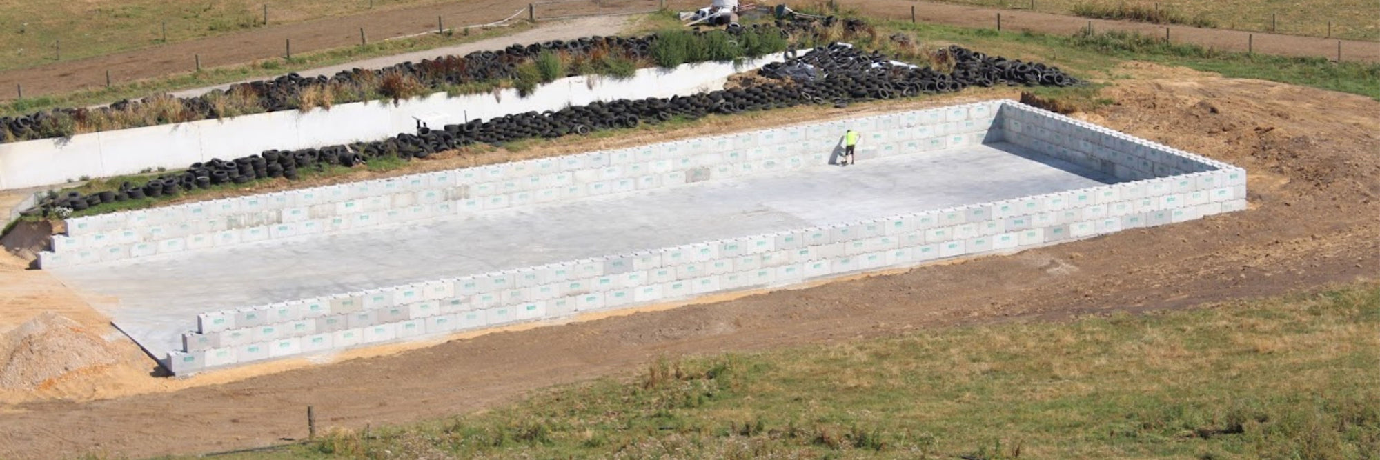 Large Interbloc silage bunker with a man sweeping the bay