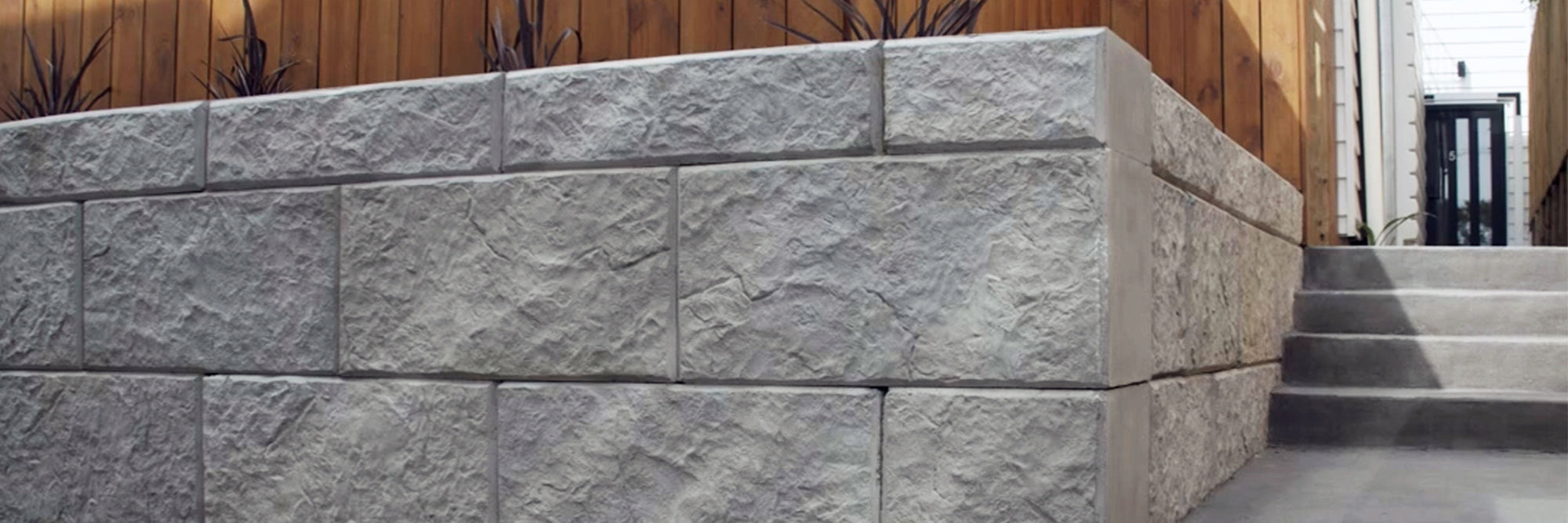 Stonebloc concrete blocks forming a retaining wall in an infill housing development